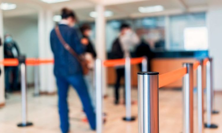 People waiting in line at bank.
