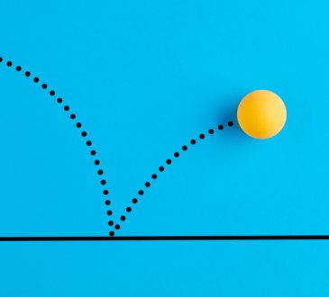 Yellow ping pong ball bouncing on blue background