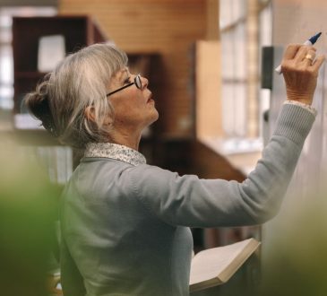 Woman writing on whiteboard