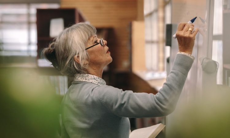 Woman writing on whiteboard