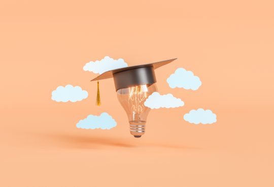 Photo illustration of lightbulb wearing graduation cap amid floating white clouds on peach background