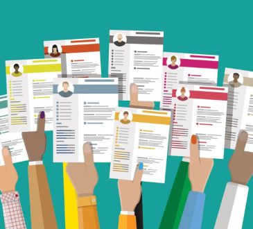 Illustration of many hands holding up resumes