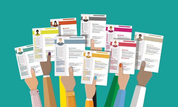 Illustration of many hands holding up resumes