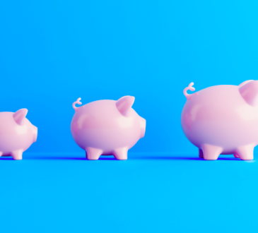 Three pink piggy banks in a row, increasing in size from left to right, on a blue background