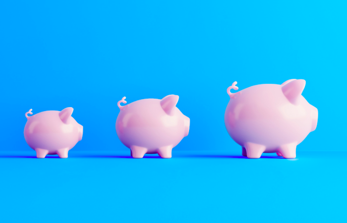 Three pink piggy banks in a row, increasing in size from left to right, on a blue background