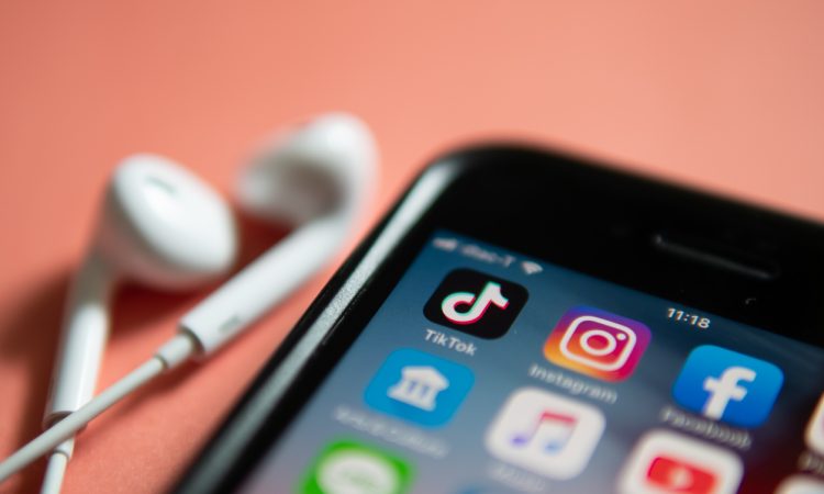 iPhone 7 showing its screen with TikTok and other social media application icons.