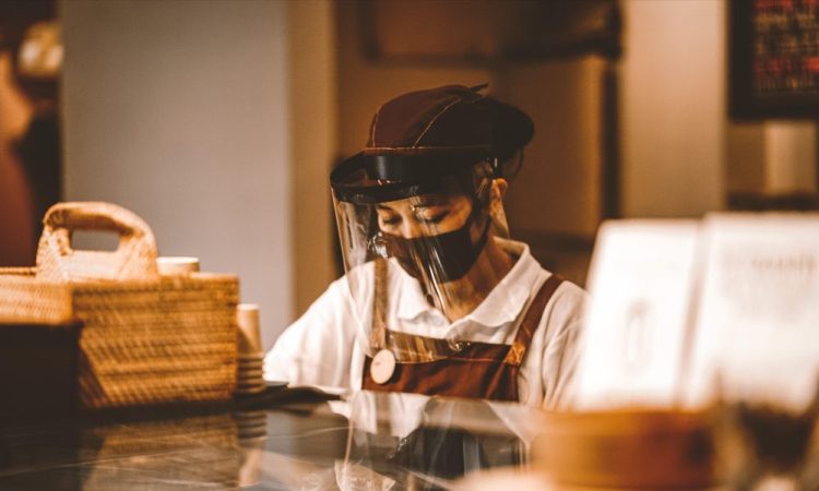 Barista wearing mask and face shield.