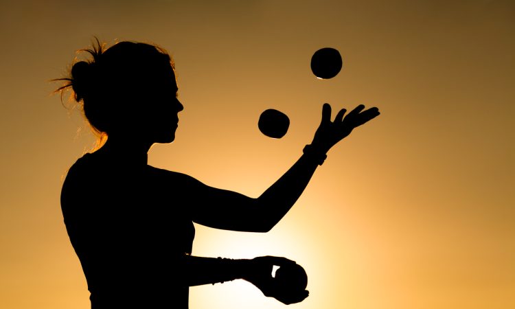 Silhouette of woman juggling