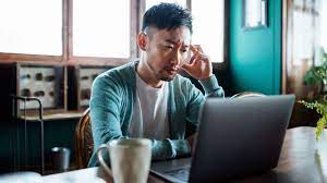 Man concentrating while looking at computer