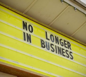 Store sign that reads "No longer in business"