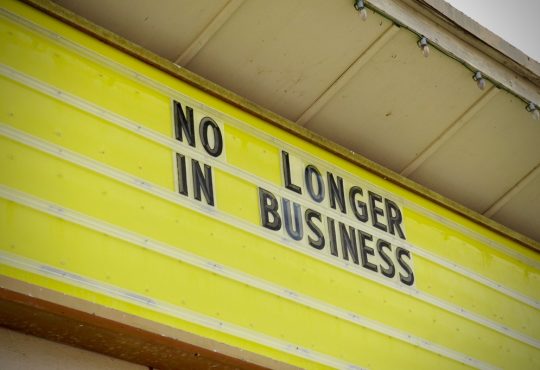Store sign that reads "No longer in business"