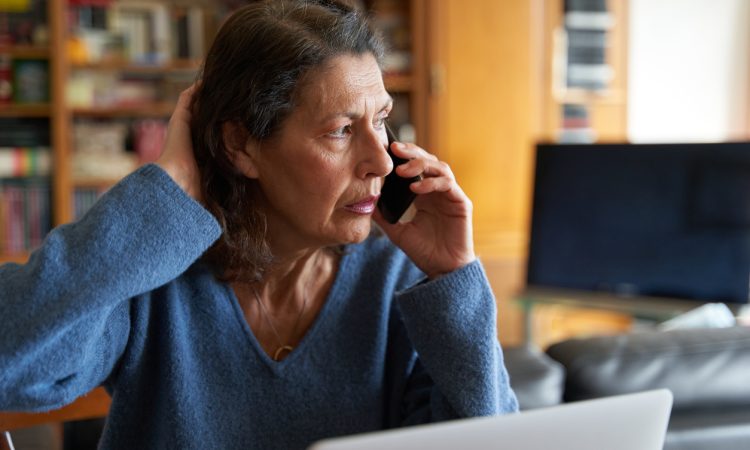 Woman stressed on phone call.