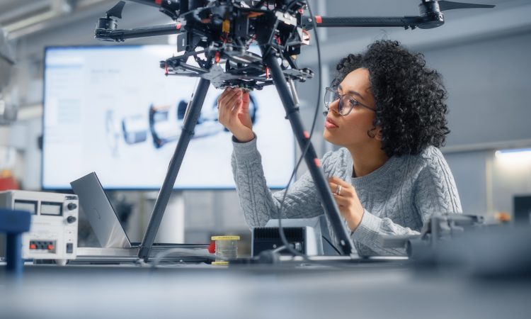 Woman working on drone in computer lab