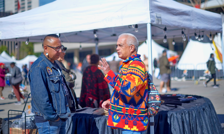 Two indigenous men talking to each other at Toronto city Hall’s Nathan Phillips Square for National Day for Truth and Reconciliation.