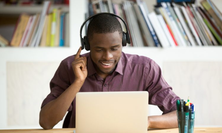 Man wearing headphones sitting at laptop