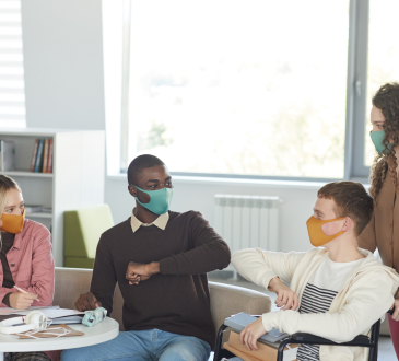 Group of people talking and wearing medical masks