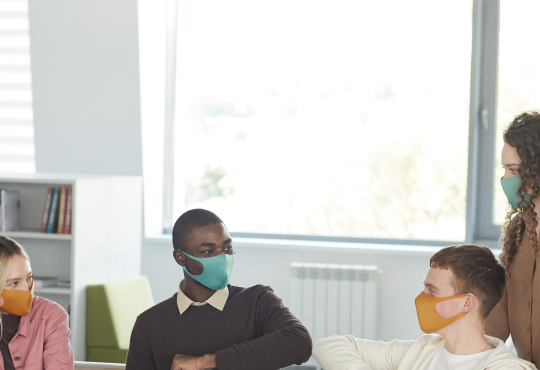 Group of people talking and wearing medical masks