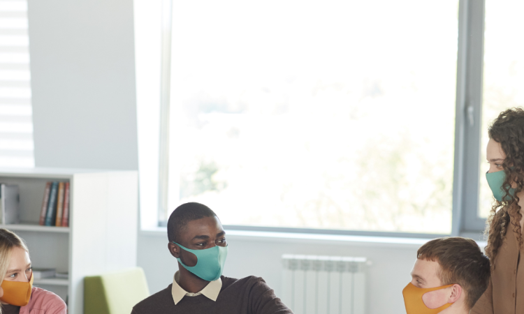 Group of people talking and wearing medical masks