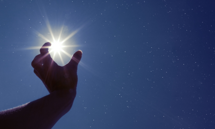 Hand reaching for brightest star in the sky