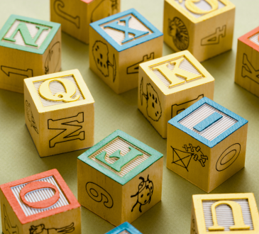 Building blocks with letters on them and pictures on the other sides