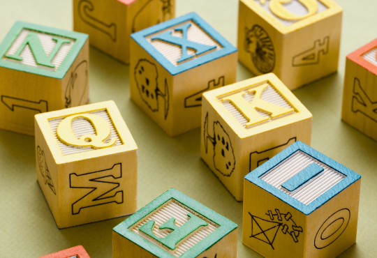 Building blocks with letters on them and pictures on the other sides