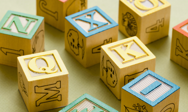 Building blocks with letters on them and pictures on the other sides
