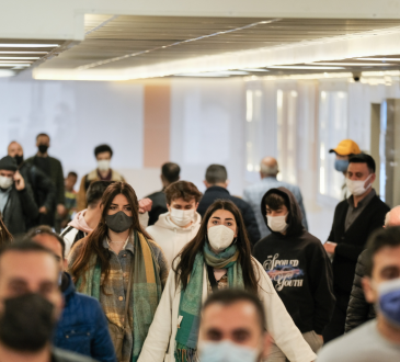 Group of people walking during pandemic, wearing masks