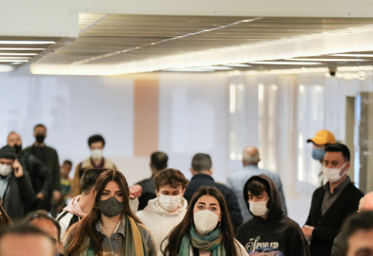 Group of people walking during pandemic, wearing masks