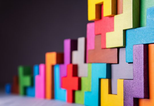 Geometric, colourful blocks connected in stack