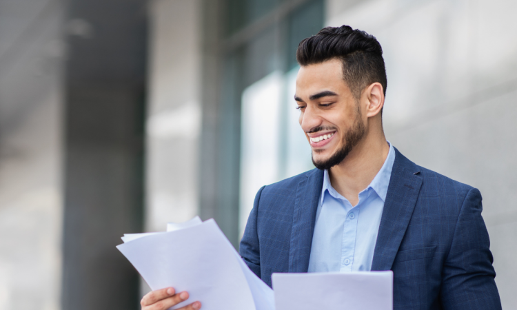 Man in blazer preparing for interview by reading papers