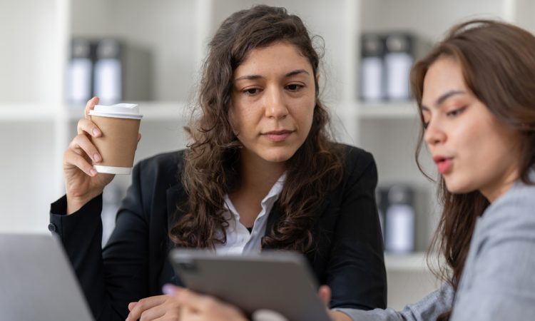 Two women talking in office