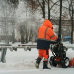 Municipal city service cleans road from snow after blizzard in the public park.