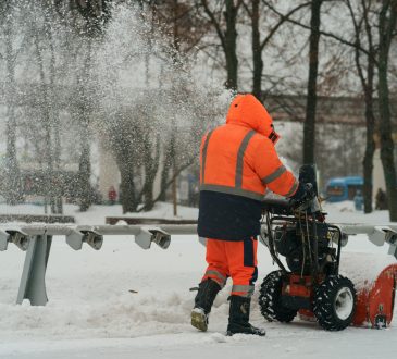 Municipal city service cleans road from snow after blizzard in the public park.