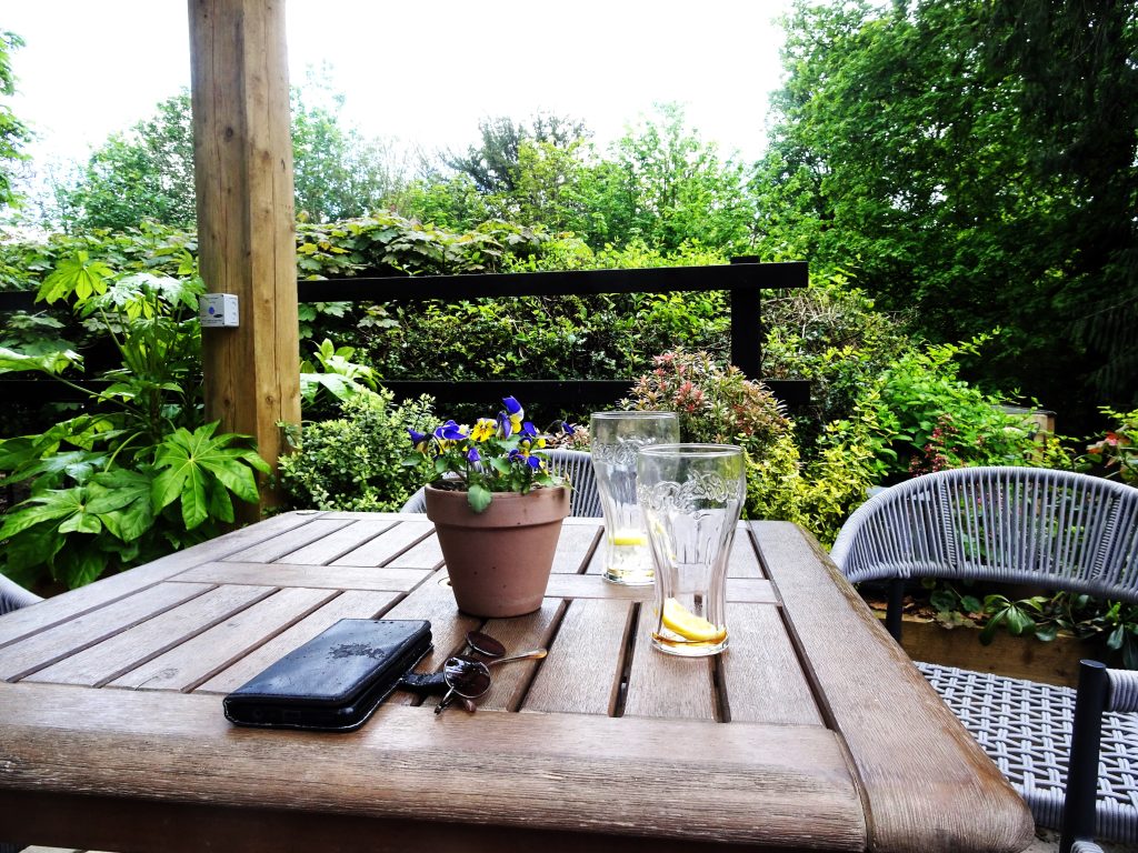 Empty glasses sit on a patio table.