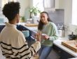 Mother Talking With Teenage Daughter At Home In Kitchen