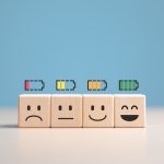 Percent of battery level from sadness to smiley face on wooden cubes