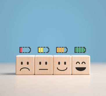 Percent of battery level from sadness to smiley face on wooden cubes