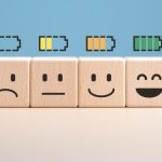 Percent of battery level from sadness to smiley face on wooden cubes
