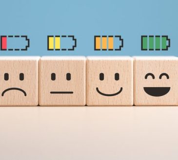 Percent of battery level from sadness to smiley face on wooden cubes