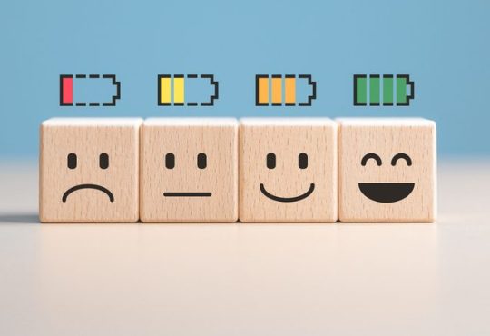 Percent of battery level from sadness to smiley face on wooden cubes