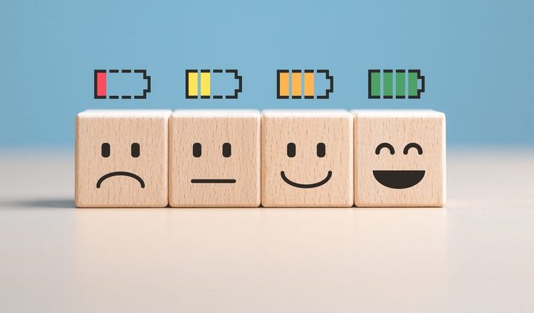 Percent of battery level from sadness to smiley face on wooden cubes