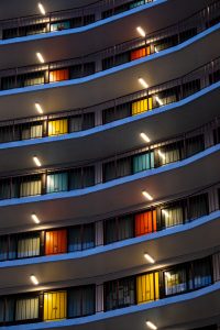 Picture of outside of hotel, with colour-coordinated curtains for rooms on each floor