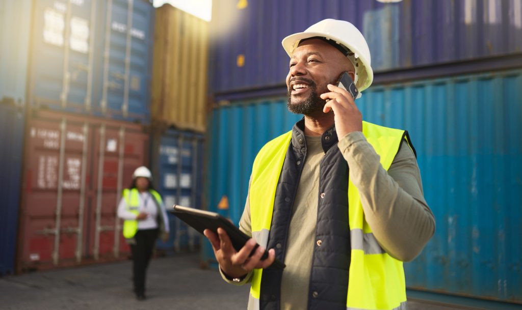 Construction worker on the phone in shipyard