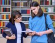 female teacher helping male student.