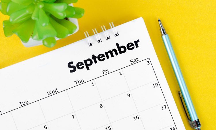 Corner of a desk calendar with September written on it.