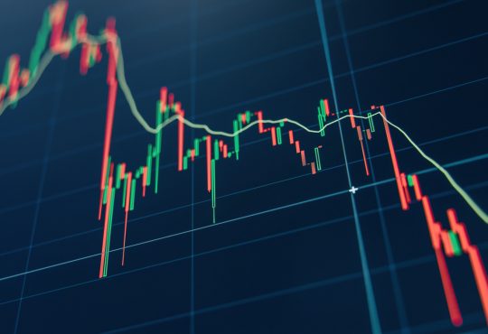 Crypto diagram with green and red candlesticks on blue display.