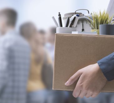 Person carrying box filled with office items