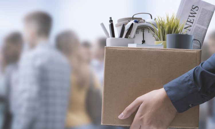 Person carrying box filled with office items