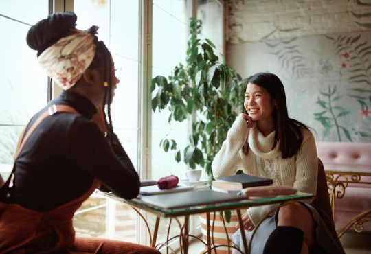 Two women talking in cafe