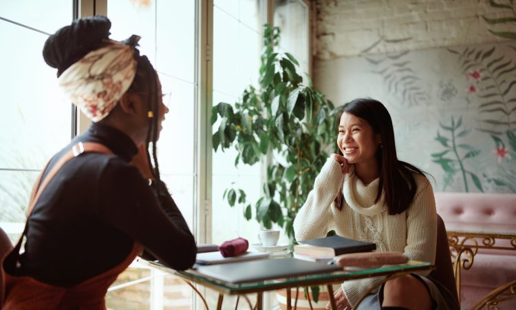 Two women talking in cafe